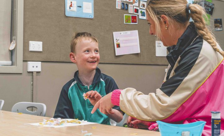 Student and teacher share engaged, supportive classroom moment
